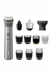 Philips grooming kit includes a metallic silver trimmer with various black and white attachment combs and a nose hair trimmer.
