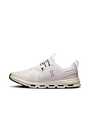 White sneaker with mesh upper, round laces, and rubber sole featuring hollow circular cutouts. Logo displayed on the side.