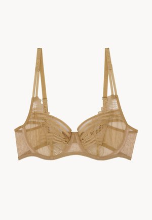 Soutien-gorge en dentelle couleur beige clair avec bonnets transparents, motifs géométriques complexes, bretelles réglables et bande lisse pour un maintien optimal.