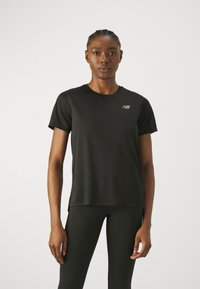 Black athletic t-shirt made from a lightweight, breathable fabric. Features a crew neck, short sleeves, and a subtle logo on the chest.