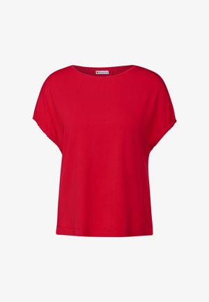 Czerwony T-shirt z krótkim rękawem, wykonany z miękkiego materiału o luźnym kroju. Posiada podwinięte akcenty na rękawach oraz szeroki, okrągły dekolt.