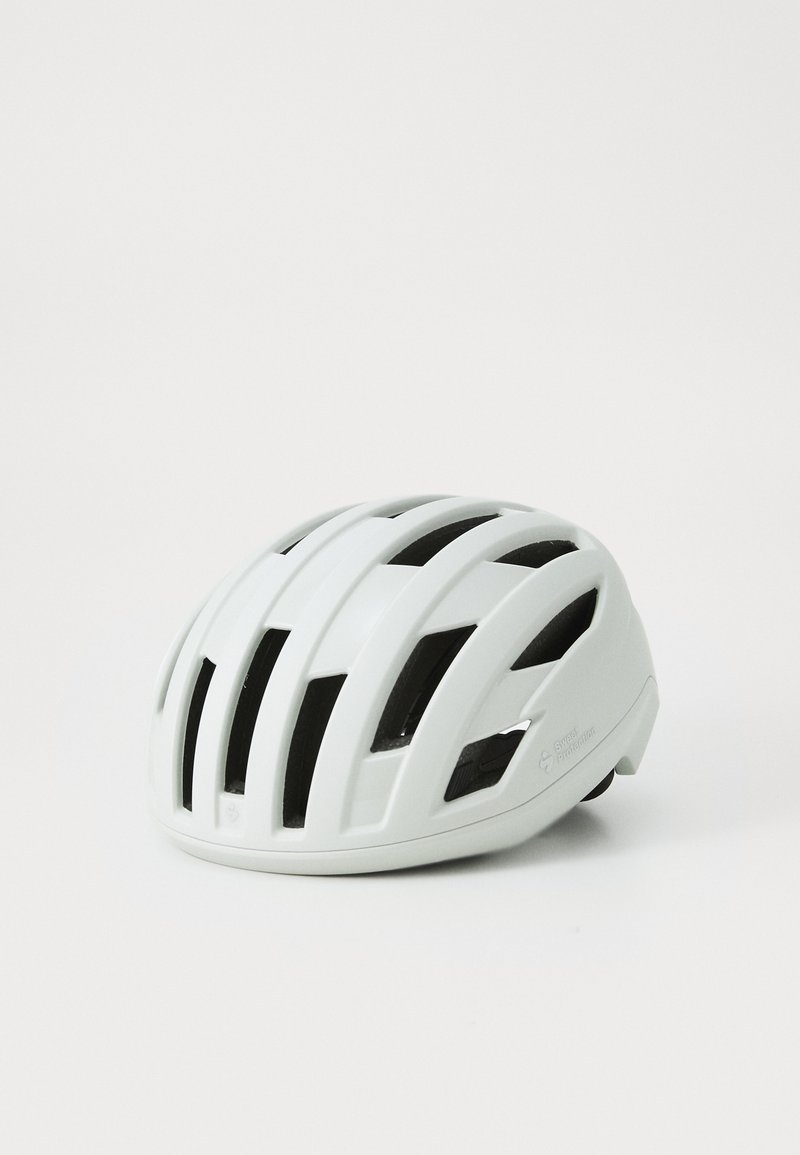 Weißer Fahrradhelm mit mehreren Belüftungsöffnungen, einer glatten Oberfläche und einem verstellbaren Riemen. Leichtes Design, das sich gut fürs Radfahren eignet.