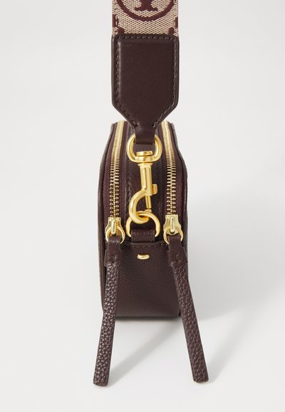 Brown leather bag with a textured finish, dual gold zippers, and a fabric shoulder strap featuring a logo pattern. Features a leather tab.