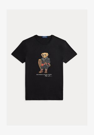 Black cotton t-shirt featuring a graphic of a bear in a coat and sunglasses, holding a racquet, with "Polo Bear by Ralph Lauren" printed below.