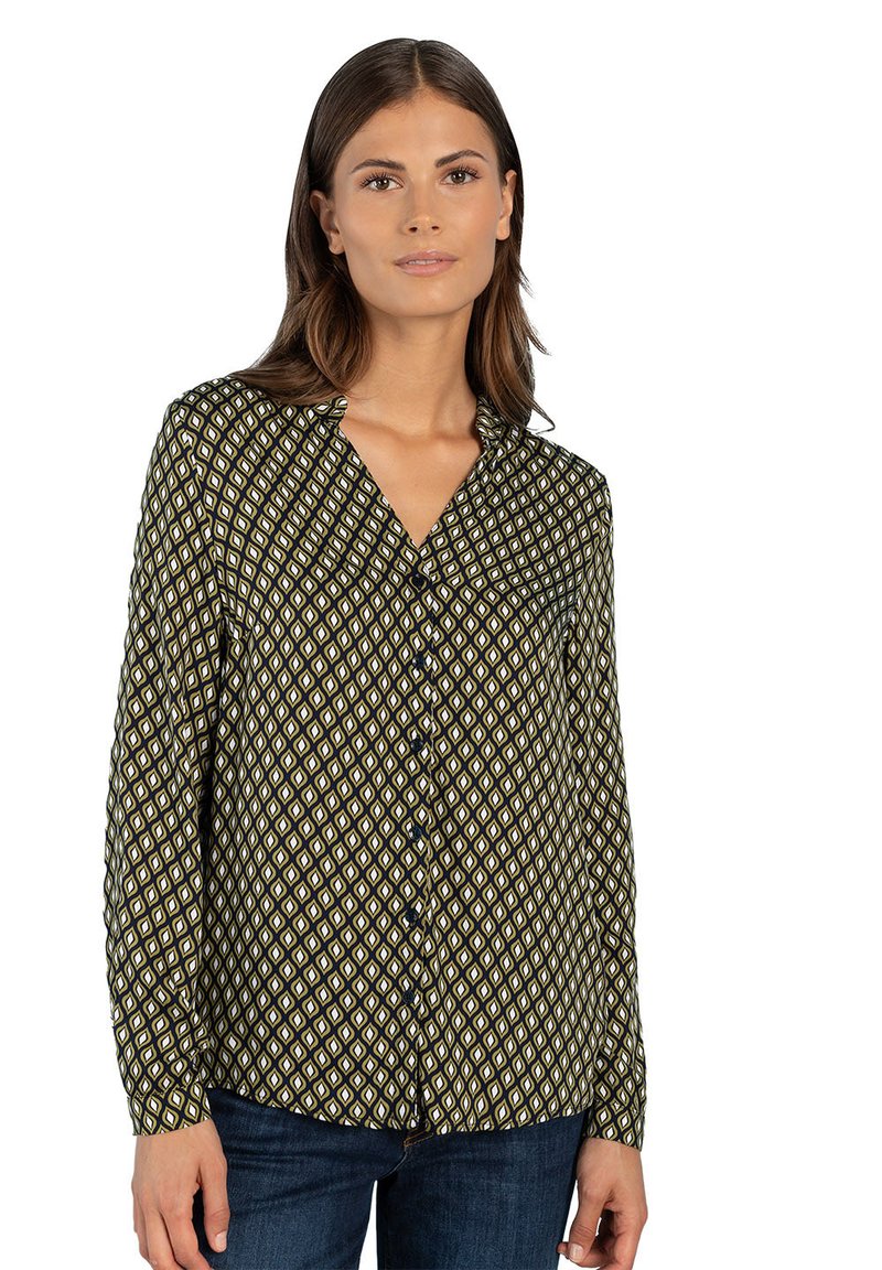 Long-sleeve shirt in dark green with a geometric diamond print in yellow and white. Features a button-down front and collar.