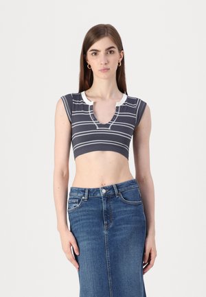 Grey and white striped cropped top with a V-neck and ribbed texture, paired with a high-waisted blue denim skirt.