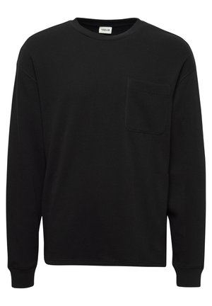 Svart långärmad skjorta i texturerad tyg, med rund halsringning och en bröstficka. Enkelt design med ribbade ärmslut.