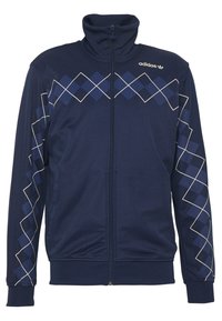 Chaqueta de cremallera navy con cuello alto, que presenta un patrón de diamantes en diferentes tonos de azul y acentos en blanco en las mangas. Confeccionada en tela suave.