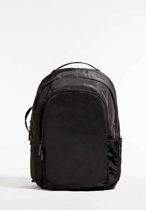 Black backpack made of nylon with a smooth texture, featuring a rounded shape, adjustable straps, and a zippered front pocket.