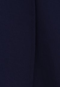 Navy blue fabric with a smooth texture and subtle sheen. Features a seam running vertically, indicating structure and design detail.