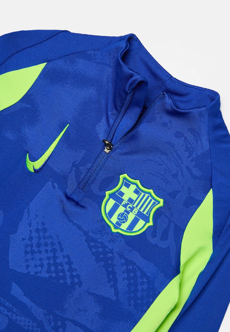 Haut de sport bleu et vert fluo à zip quart avec le logo Nike et le blason du FC Barcelone sur la poitrine.
