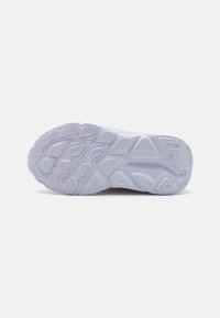 White rubber sneaker sole with textured patterns, featuring various shapes and grooved sections for grip and traction.