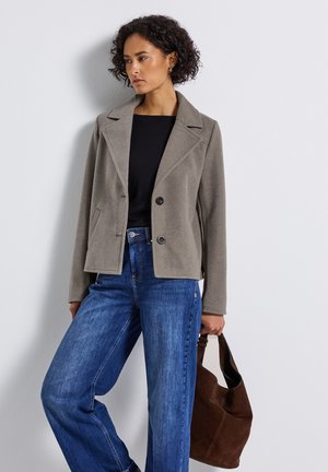 Gray cropped jacket with notched lapels, two front buttons, and side pockets, paired with blue wide-leg jeans and a brown handbag.