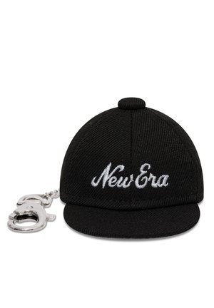 Fekete miniatűr baseballsapka kulcstartó fehér "New Era" hímzéssel és egy hozzákapcsolt ezüst színű fém csipesszel fehér háttéren.