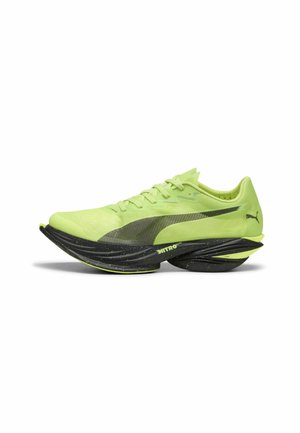 Bright yellow-green Puma running shoe with thick black speckled sole labeled Nitro Elite and Puma logo on side and heel.