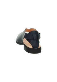 Dark blue leather sandal with an open back, minimal design, and a black rubber sole. Features a small strap at the heel.