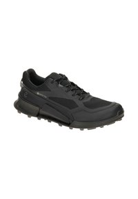 Black athletic shoe featuring a textured upper with mesh accents, a cushioned sole, and rubber traction outsole for enhanced grip.