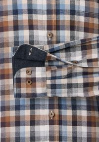 Leichte karierte Hemd in Braun-, Blau- und Weißtönen. Verfügt über einen Knopfleiste, einen abgerundeten Kragen und kontrastierende, denimartige Manschetten.