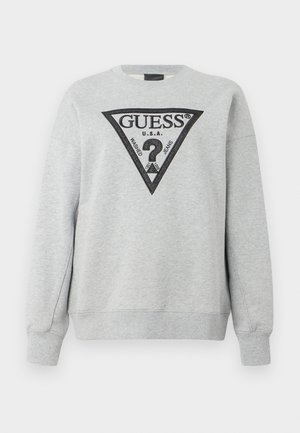 Svijetlosivi dukserica dugih rukava s crnim trokutastim logotipom "GUESS U.S.A." i upitnikom na prsima.
