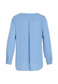 Blouse bleu clair à manches longues avec empiècement dos et pli creux central, poignets boutonnés et coupe ample.