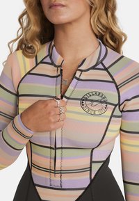 Wetsuit top made of stretchy fabric featuring pastel horizontal stripes in pink, yellow, and purple, with a black zipper and logo accent.