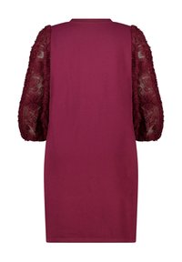 Robe bordeaux avec des manches courtes en forme de poire texturées en matériau transparent, ornée de broderies florales. Corps lisse avec encolure ronde.
