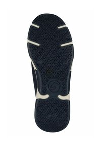 Semelle de chaussure en caoutchouc noir avec un motif de grip texturé, des accents blancs et un logo circulaire au centre. Présente des rainures pour plus de flexibilité.