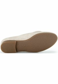Beige suede shoe sole with a textured brown rubber bottom; features embossed logo and side ridges for grip.