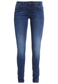 Jeans de corte ajustado en denim azul oscuro. Disponen de un clásico diseño de cinco bolsillos, un sutil desgastado en los muslos y un cierre con botón y cremallera estándar.