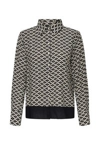 Chemise à manches longues en tissu beige, présentant un motif floral noir et un ourlet noir contrastant. Col classique et fermeture à boutons sur le devant.