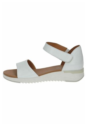 Hvid læder sandal med åben tå, ankelrem, lav kilehæl og polstret brun indersål.