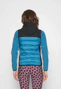 Blue and black hooded jacket with a padded texture at the back, featuring a fitted design and contrasting color panels.