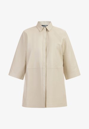 Beige leather shirt jacket with a collared neck, button closure, short sleeves, and a straight silhouette. Smooth texture with minimal seams.