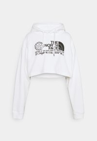 Sweat à capuche court blanc à manches longues, capuche avec cordon, et logo noir "The North Face" avec coordonnées et illustration de globe terrestre sur le devant.