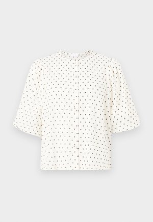 Balts īsām piedurknēm krekls ar apaļu kakla izgriezumu, kuram ir brūnas punktiņu raksts. Pogājams priekšpuse un brīva silueta. Strukturēta auduma.