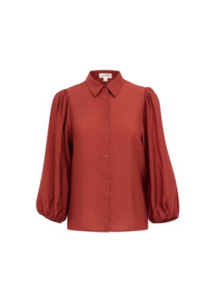 Rustfärgad blus med krage, framknappar och långa ballongärmar. Tillverkad av ett slätt tyg med rynkade detaljer vid ärmarna.
