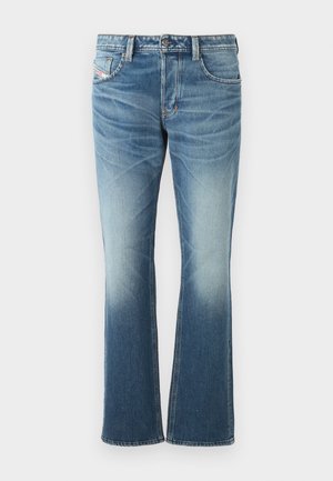 Zilās džinsa bikses ar izplūduša dizaina, ar izbalējušu mazgāšanu, piecām kabatām un kontrastējošiem diegiem. Pogas aizdare jostasvietā.