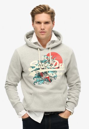 Light gray hoodie with drawstrings, front pocket, and colorful graphic design featuring a koi fish and waves. Text reads "Super Dry."