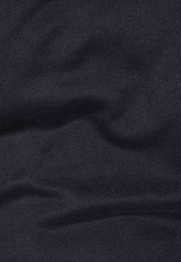 Tela azul marino oscuro con una superficie lisa y ligeramente texturizada, que muestra pliegues y arrugas suaves. Adecuada para diversos usos en prendas de vestir.