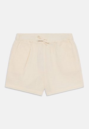 Calções de algodão bege claro com cintura elástica e cordão ajustável. Apresenta uma textura suave e dois bolsos frontais.