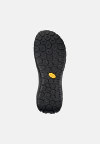 Crna guma potplate obuće s teksturiranim gripom, sa kružnim uzorcima i žutim Vibram logotipom. Veličina označena kao 42.