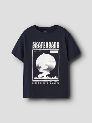 Black short-sleeve t-shirt with white graphic of skateboarder silhouette, city skyline, and text "SKATEBOARD" and "DRESS LIKE A SKATER."