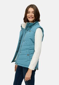Lightblue padded vest with a high collar, zip closure, and snap buttons. Features side pockets and a quilted texture. Worn over a white sweater.