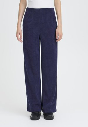 Pantaloni a gamba larga in corduroy blu navy con texture a coste verticali, vita elasticizzata e tasche laterali. Adatti per un look casual.
