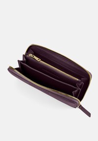 Purple leather wallet featuring a gold zipper, multiple card slots, and a zippered compartment for coins. Smooth texture and spacious design.