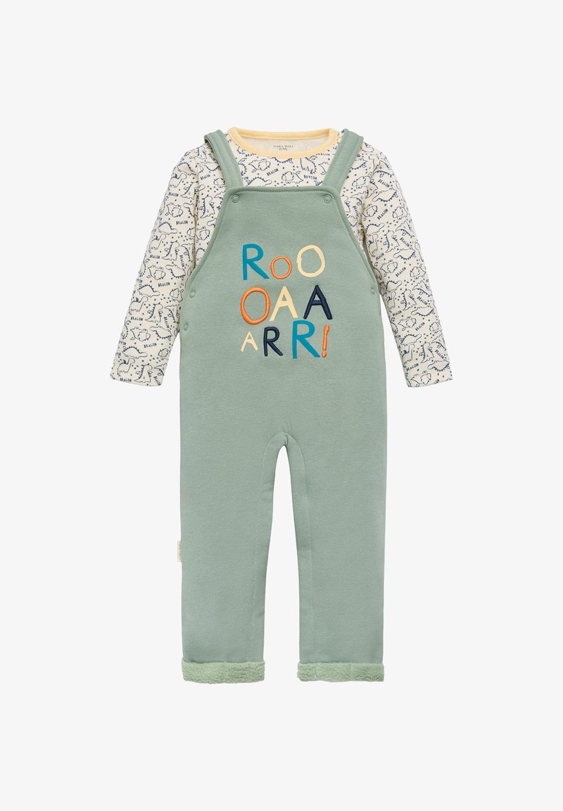 Mono verde con una textura suave, con letras coloridas bordadas "ROO OAA ARR!" y una camiseta de manga larga de color crema con un patrón de dinosaurios.
