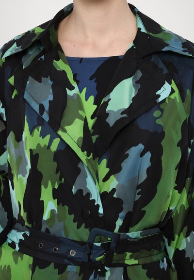 Colorful trench coat featuring a camouflage pattern in shades of green, blue, and black. Includes a belt and wide lapels. Lightweight fabric.