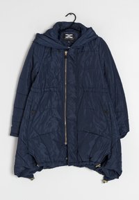 Navy blue puffer jacket with a hood, featuring a zip front, side pockets, elasticized hem, and diagonal quilted texture. Gold hardware accents.