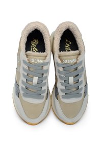 Beige and grey sneakers with a textured fur lining, featuring grey laces and branding. Materials include soft fabric and rubber soles.