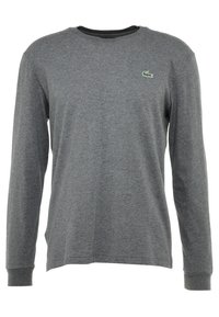 Langärmeliges graues T-Shirt aus weicher Baumwolle, mit Rundhalsausschnitt und kleinem grünem Lacoste-Logo auf der linken Brust.